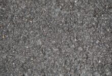Workers laying asphalt on a highway construction project