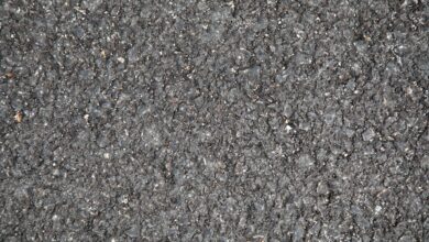 Workers laying asphalt on a highway construction project