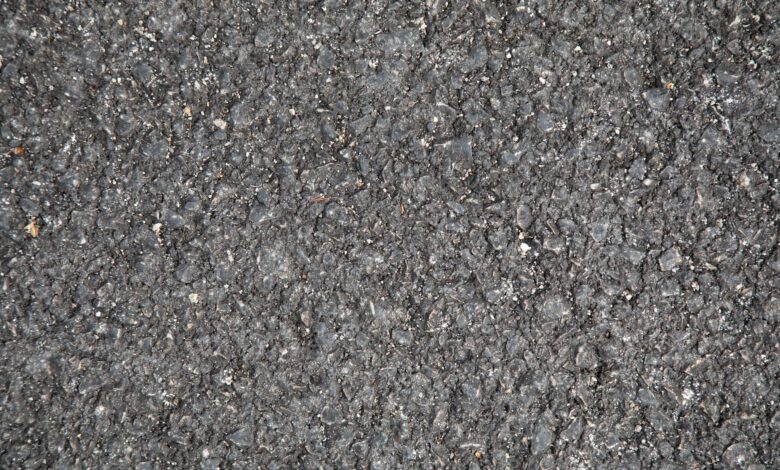Workers laying asphalt on a highway construction project