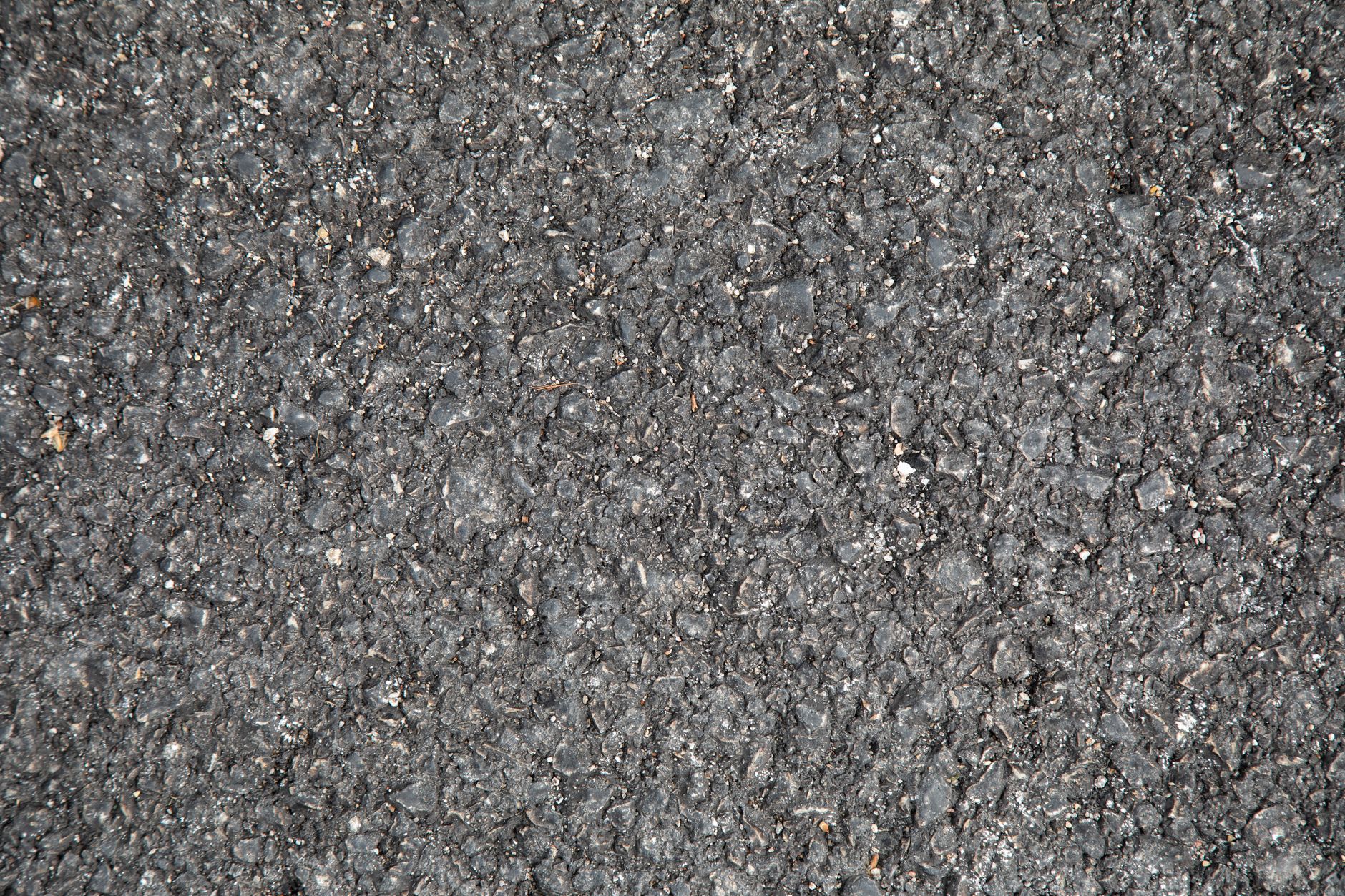 Workers laying asphalt on a highway construction project