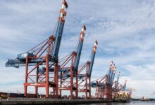 Large industrial liquid storage terminal at a commercial port facility