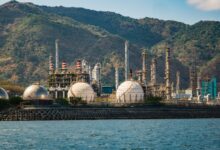 Industrial oil refinery facility with processing towers and pipelines