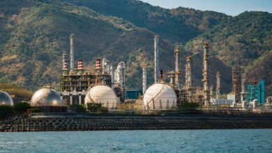 Industrial oil refinery facility with processing towers and pipelines
