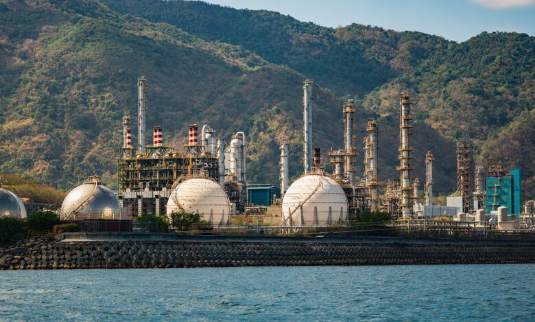 Industrial oil refinery facility with processing towers and pipelines