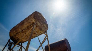 Large cylindrical fuel storage tanks at an industrial depot