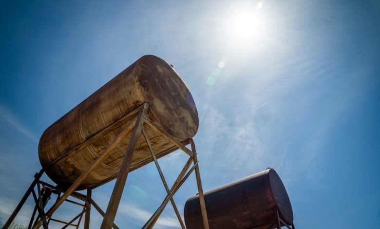 Large cylindrical fuel storage tanks at an industrial depot
