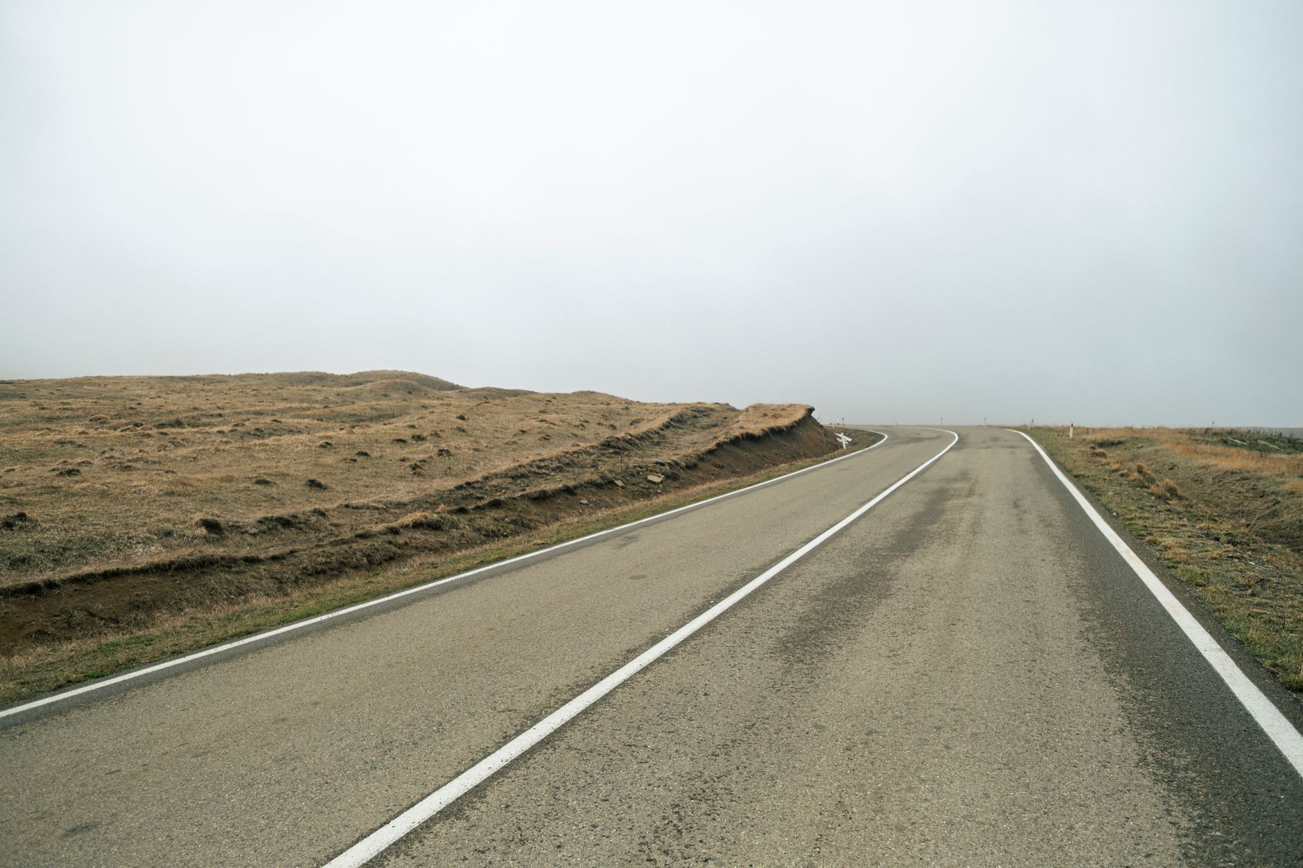 Fresh liquid asphalt being laid on a road surface during construction