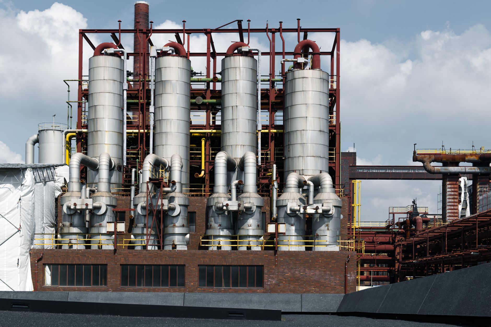 Industrial nickel refinery facility with processing equipment and smokestacks