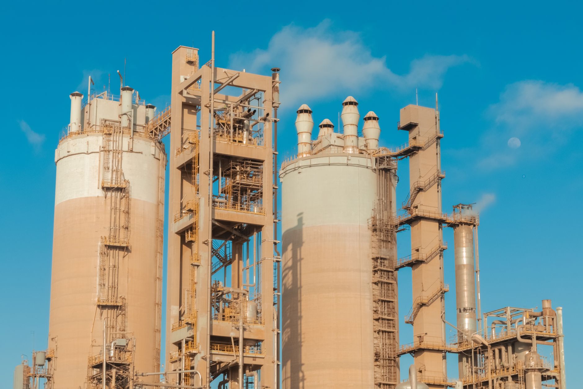 Large industrial chemical processing facility with pipes and storage tanks