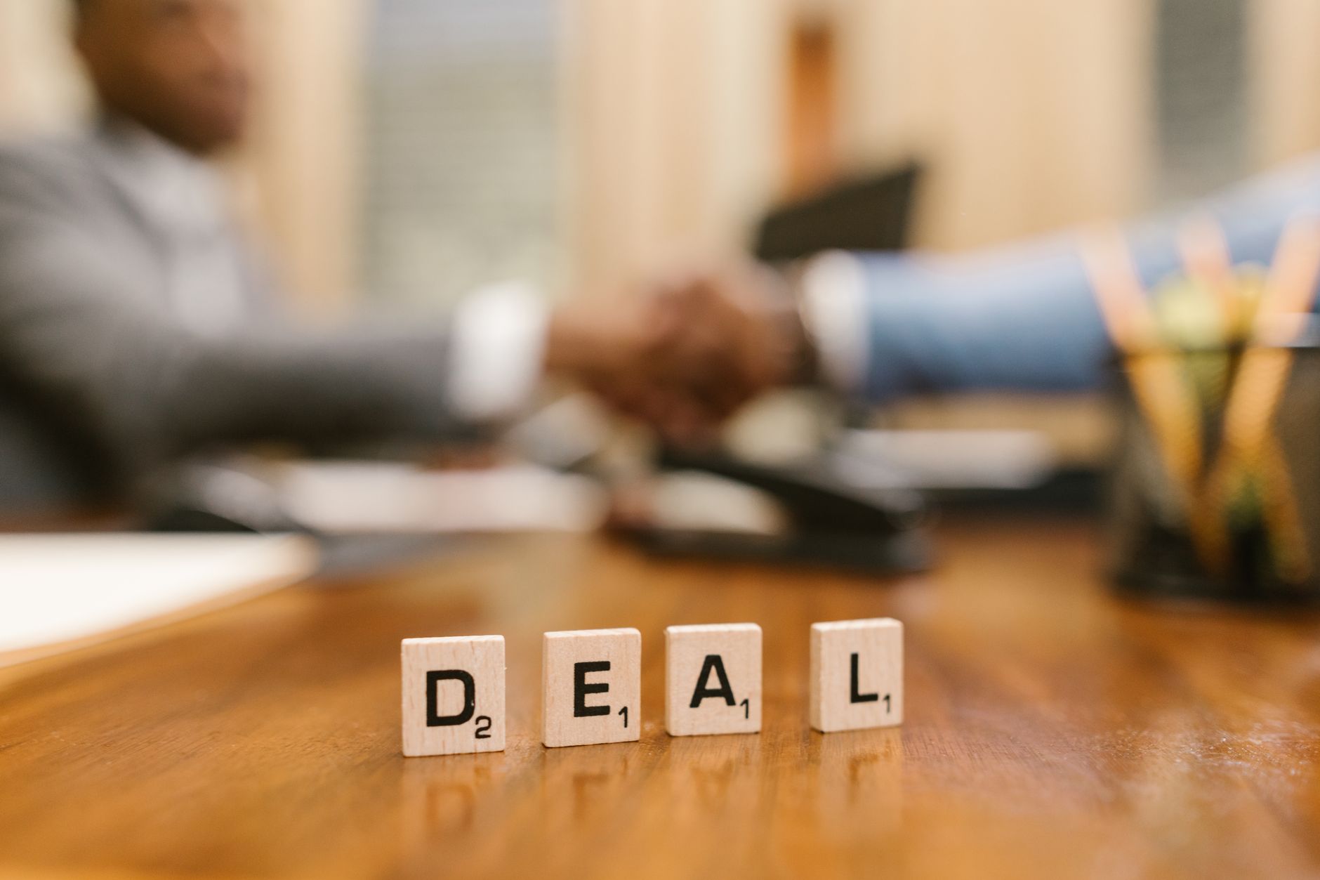 Two professionals reviewing contract documents at a conference table