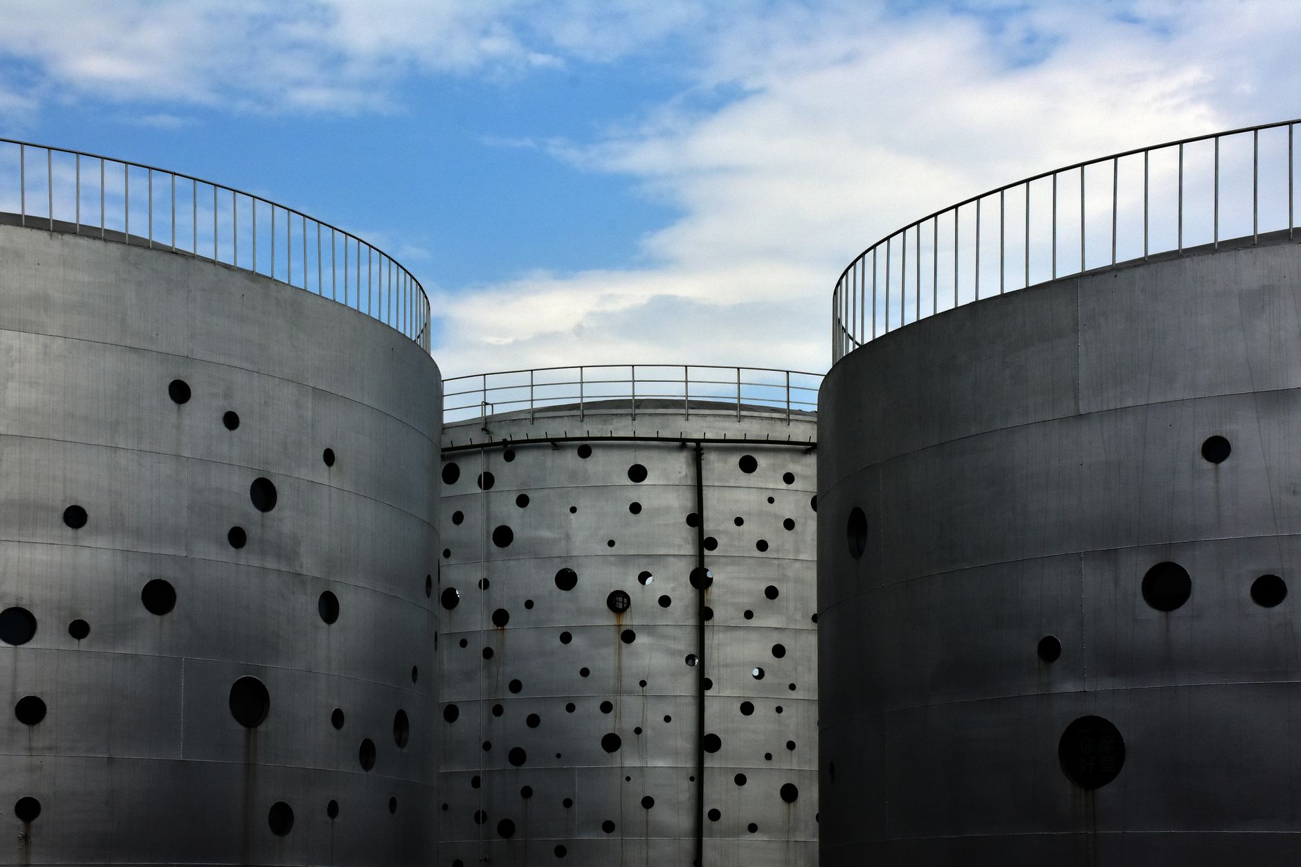 Large industrial petroleum storage tanks at a logistics terminal