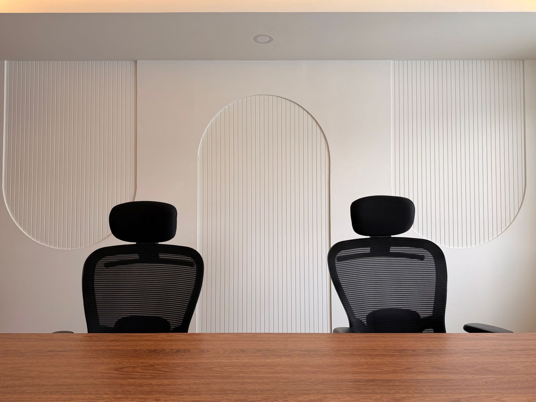 Two professionals reviewing documents in a private office setting