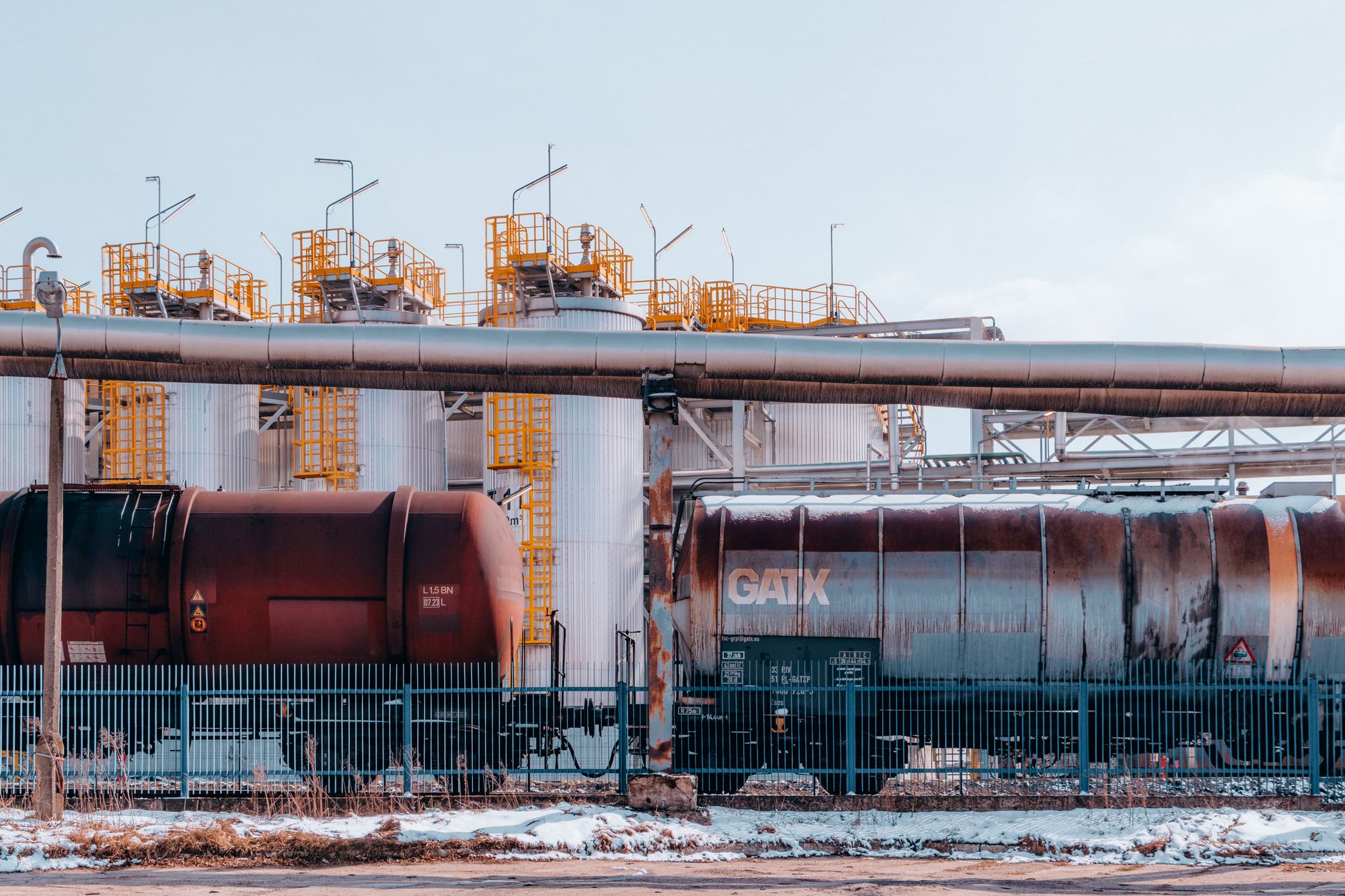 Rows of industrial chemical storage tanks at a logistics and distribution facility