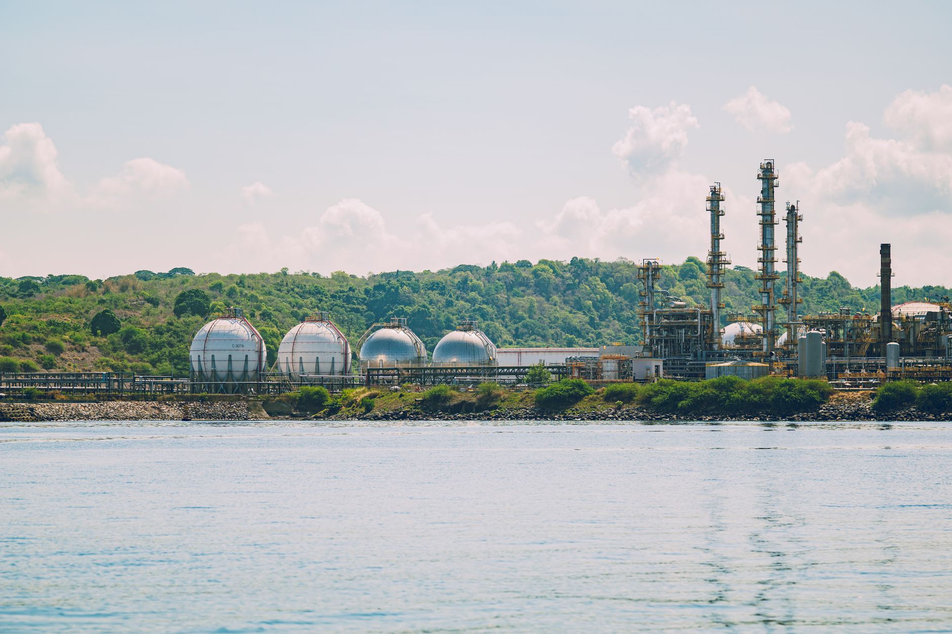 Large industrial chemical processing facility with pipes and storage tanks