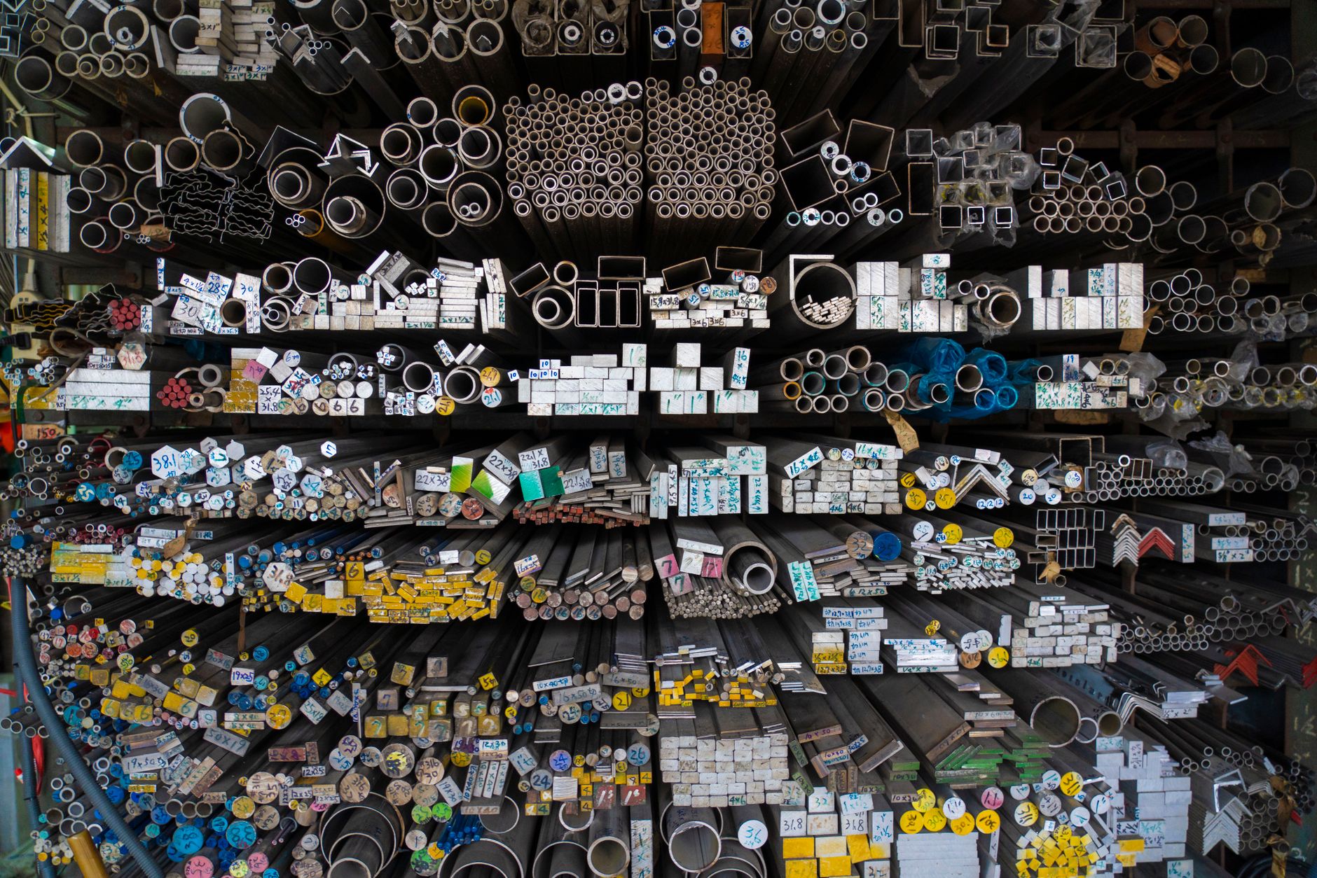 Rows of refined metal ingots stored in an industrial warehouse